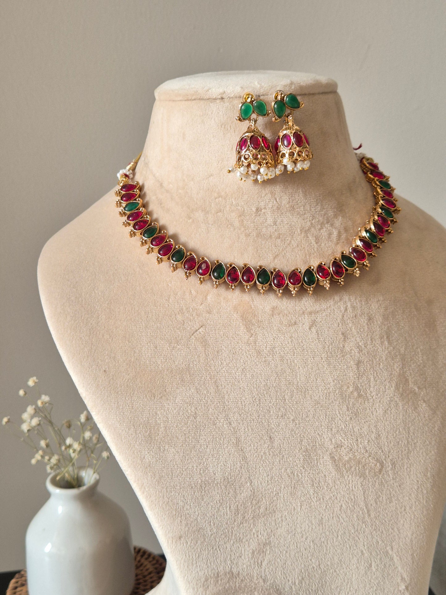 Unique reversible necklace set with pink, red, and green enamel, shown from multiple angles to illustrate versatility