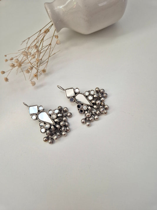 Silver glass dangle earrings, visible artistic metal details