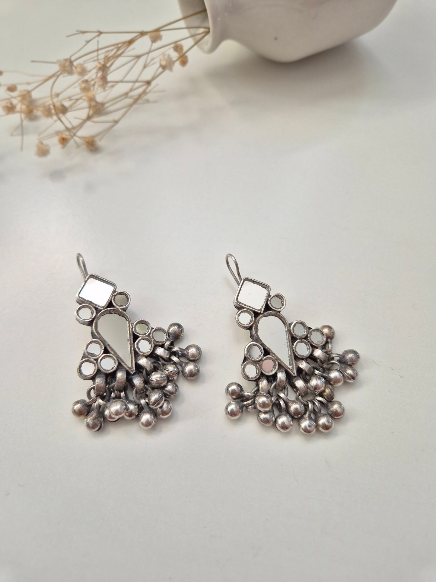 Silver glass dangle earrings, visible artistic metal details