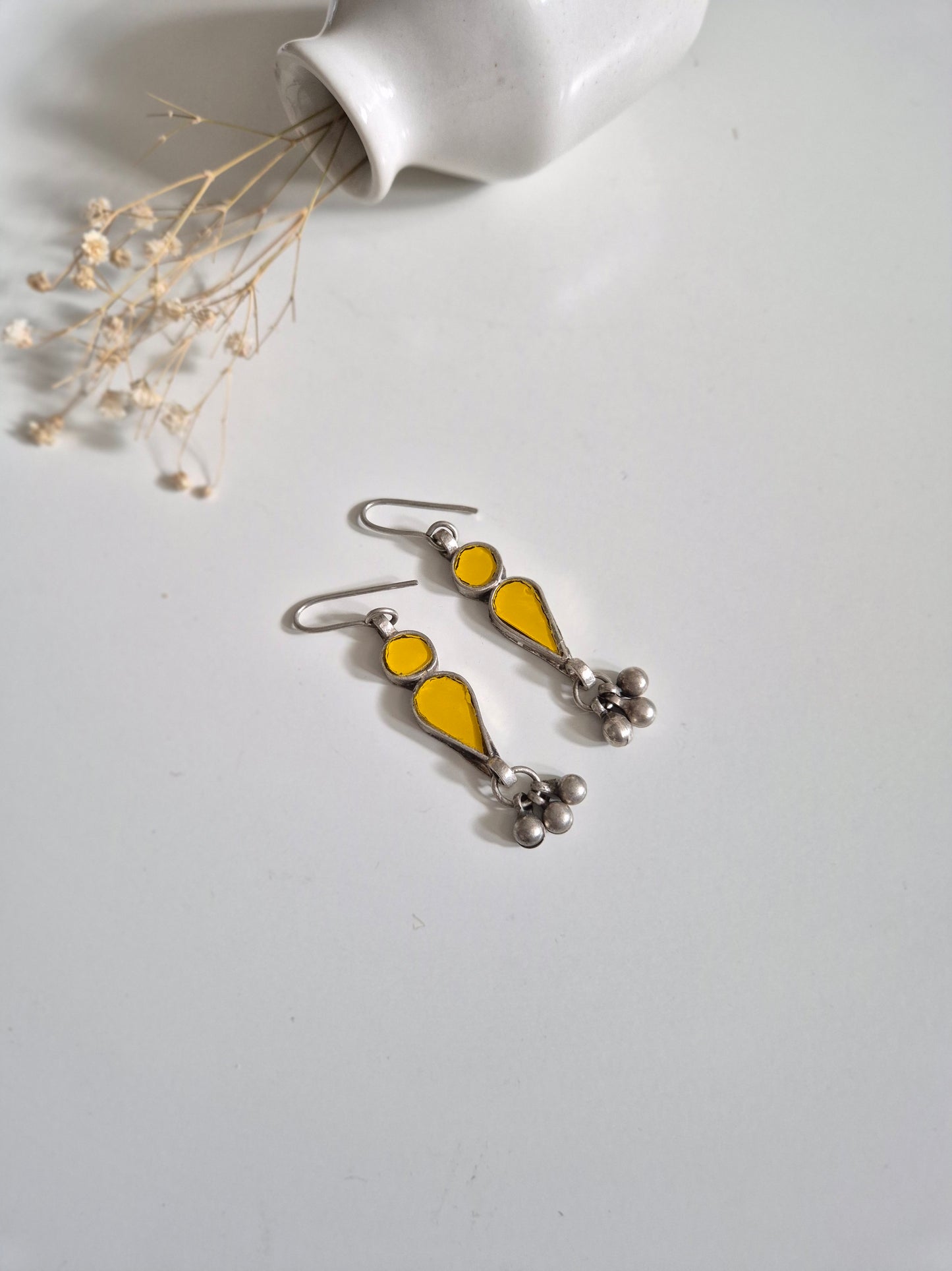Yellow glass dangle earrings, close-up for handmade detail