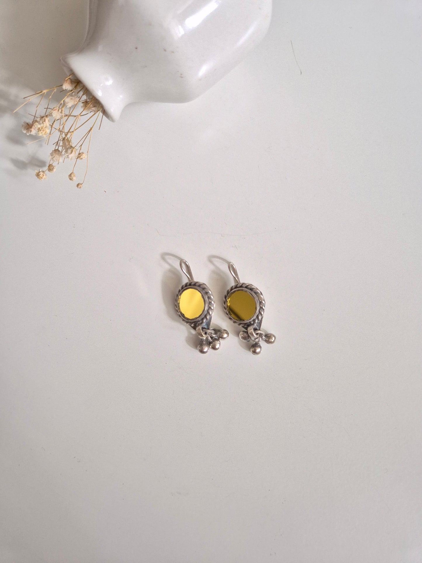 Silver and yellow glass dangle earrings standing upright
