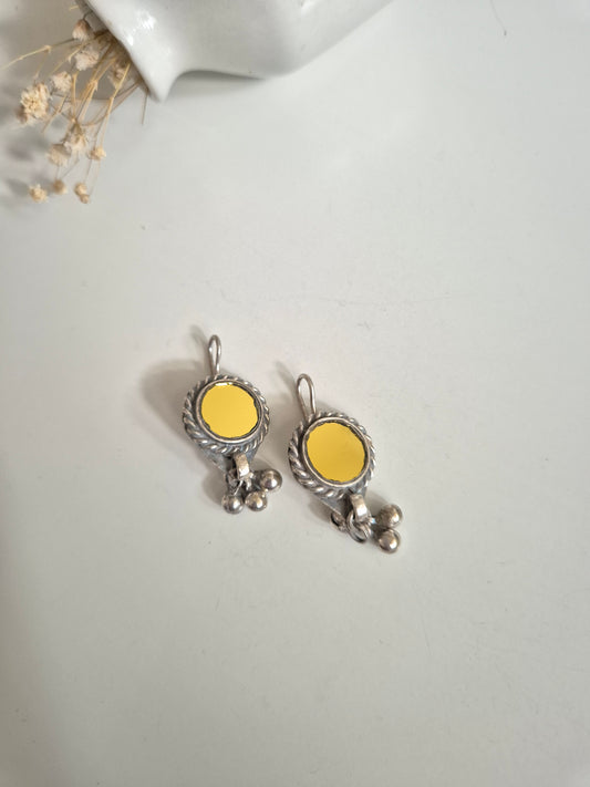 Silver and yellow glass dangle earrings standing upright