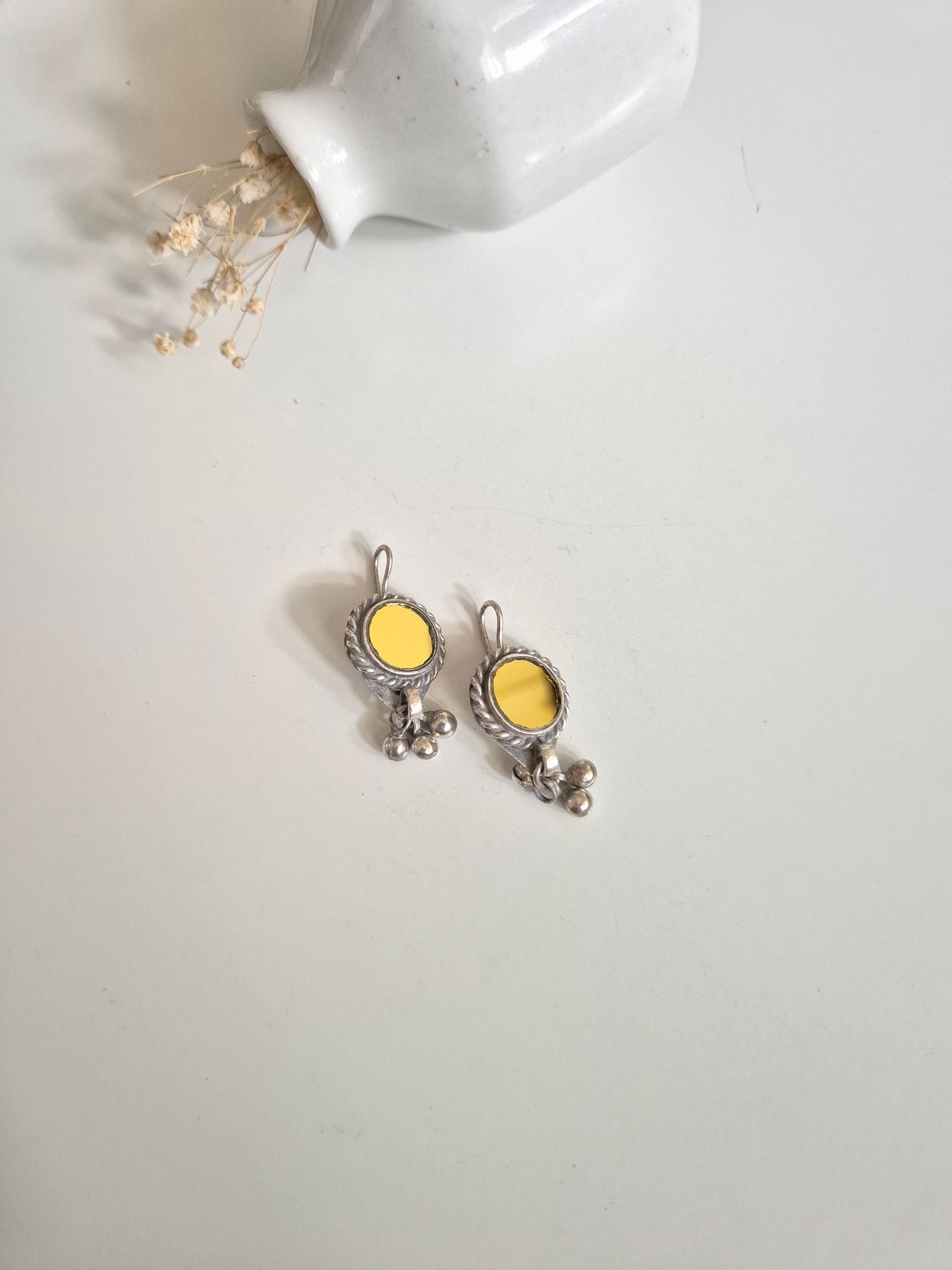 Silver and yellow glass dangle earrings standing upright