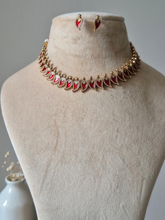 Gold and red necklace set, Aja by Naitri, displayed with matching earrings.