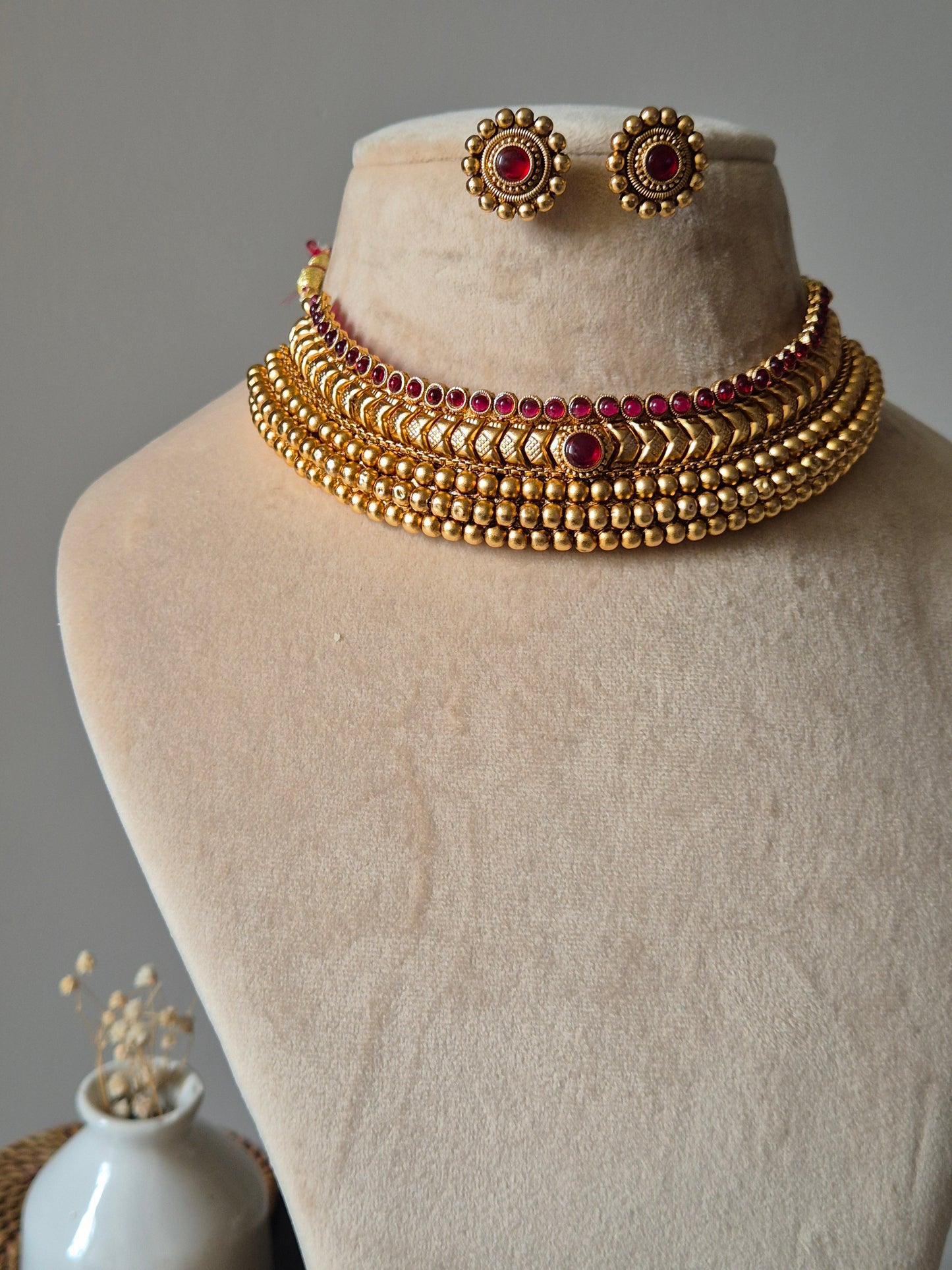 Floral gold necklace set, Harshi by Naitri on soft background.