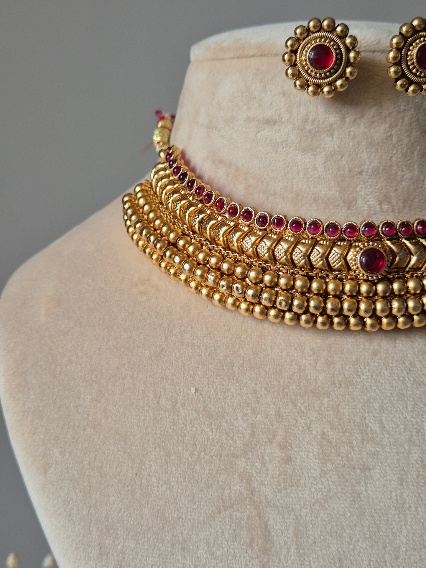 Floral gold necklace set, Harshi by Naitri on soft background.