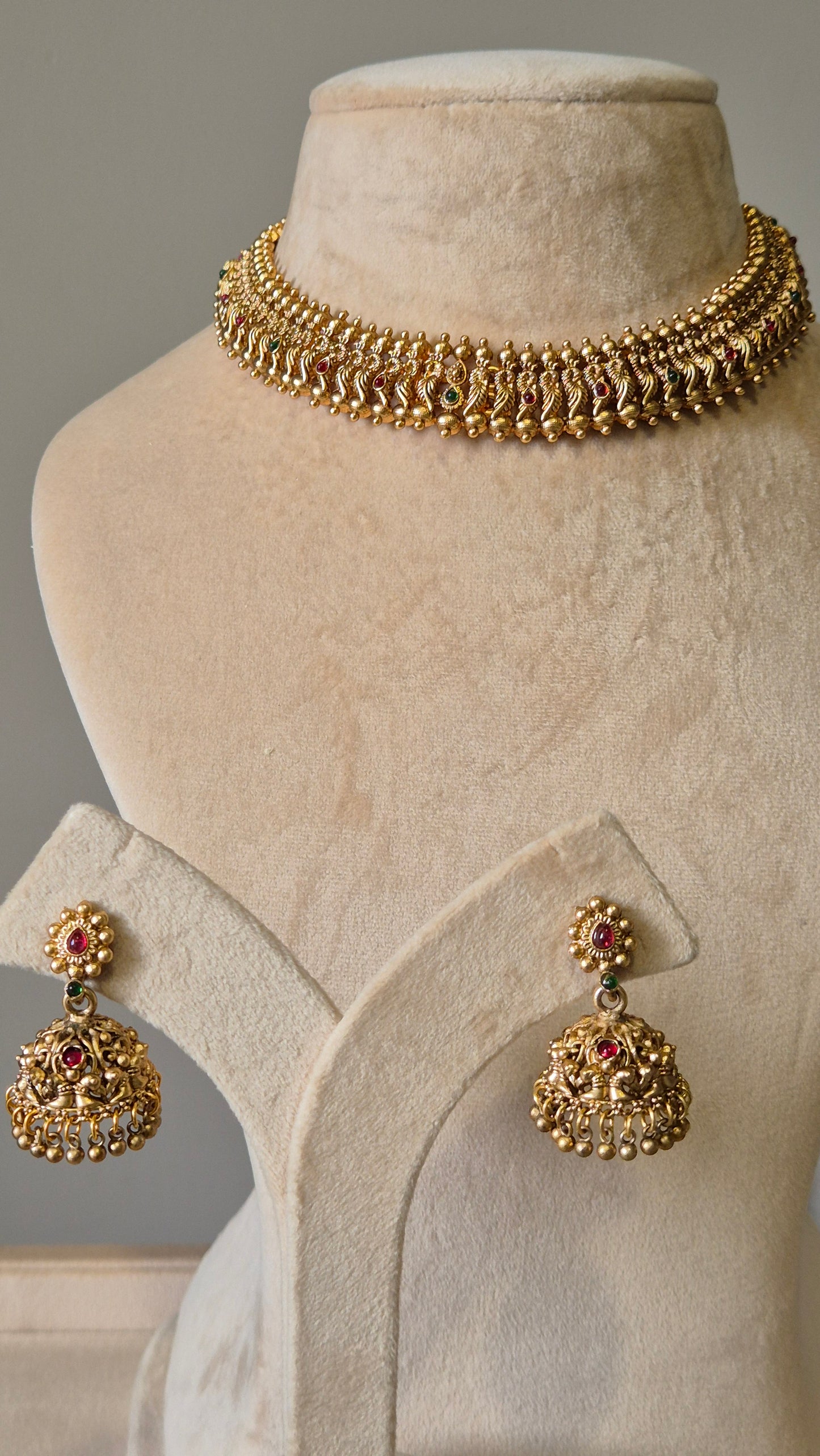 Gold necklace set with red stones, Lipsa by Naitri, classic design shown flat.