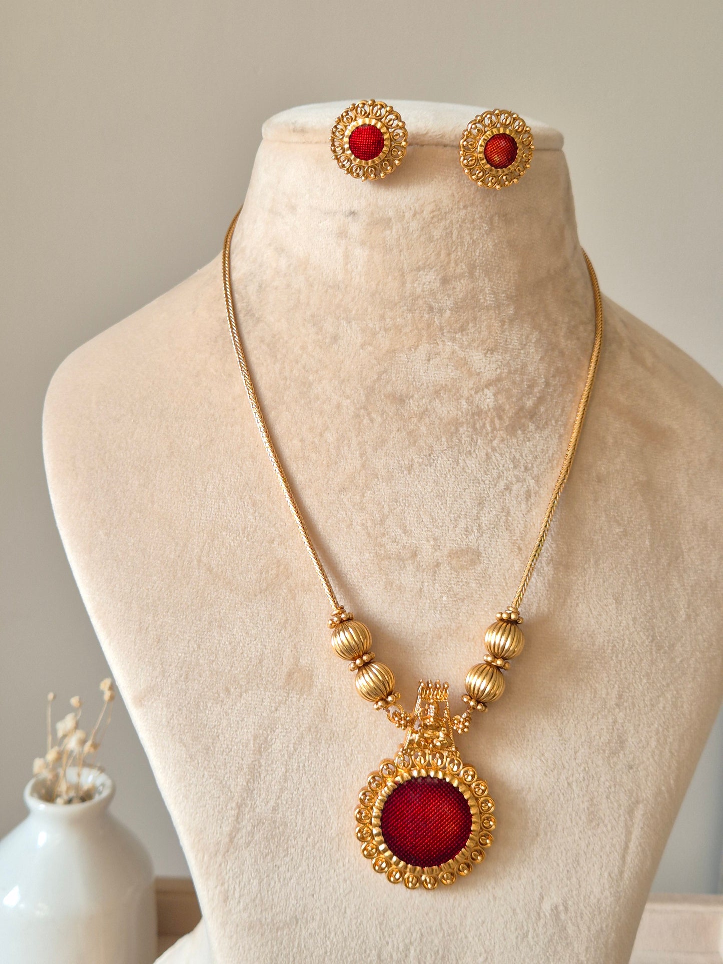 Golden necklace set, Arundhati by Naitri, shown with pendant and earrings.