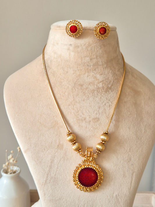 Golden necklace set, Arundhati by Naitri, shown with pendant and earrings.