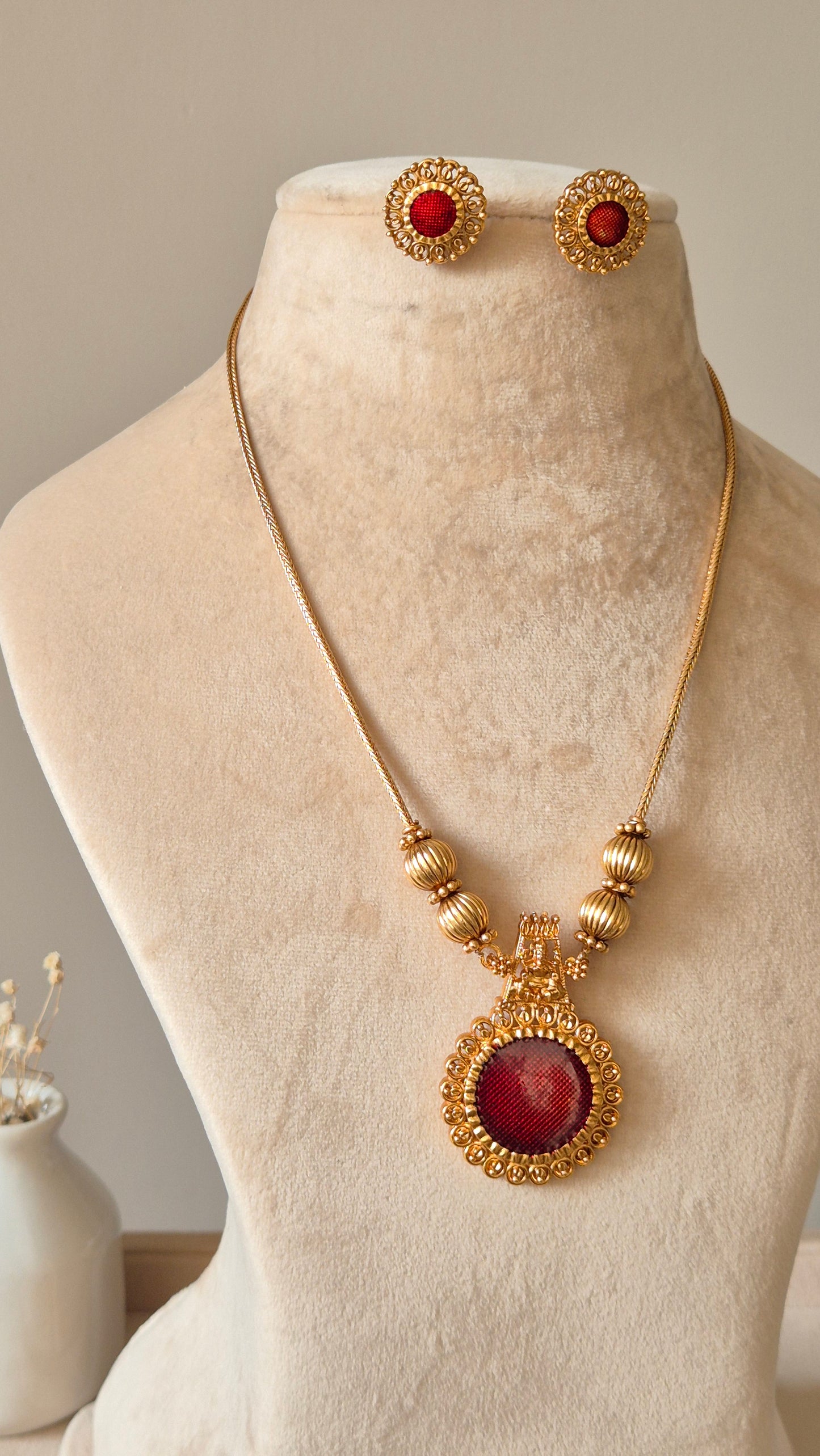 Golden necklace set, Arundhati by Naitri, shown with pendant and earrings.