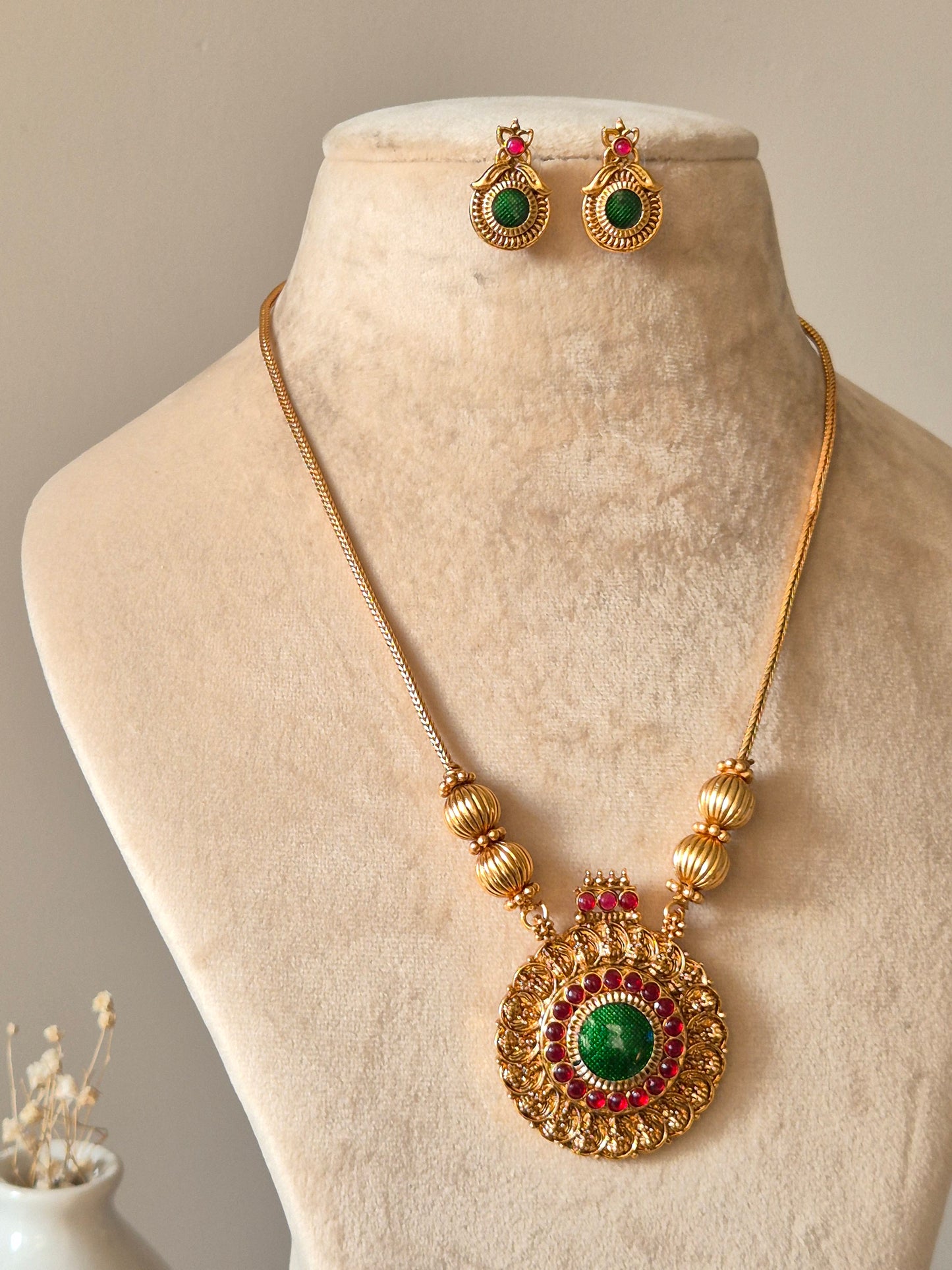Gold necklace set, Antika by Naitri, traditional style on soft background.