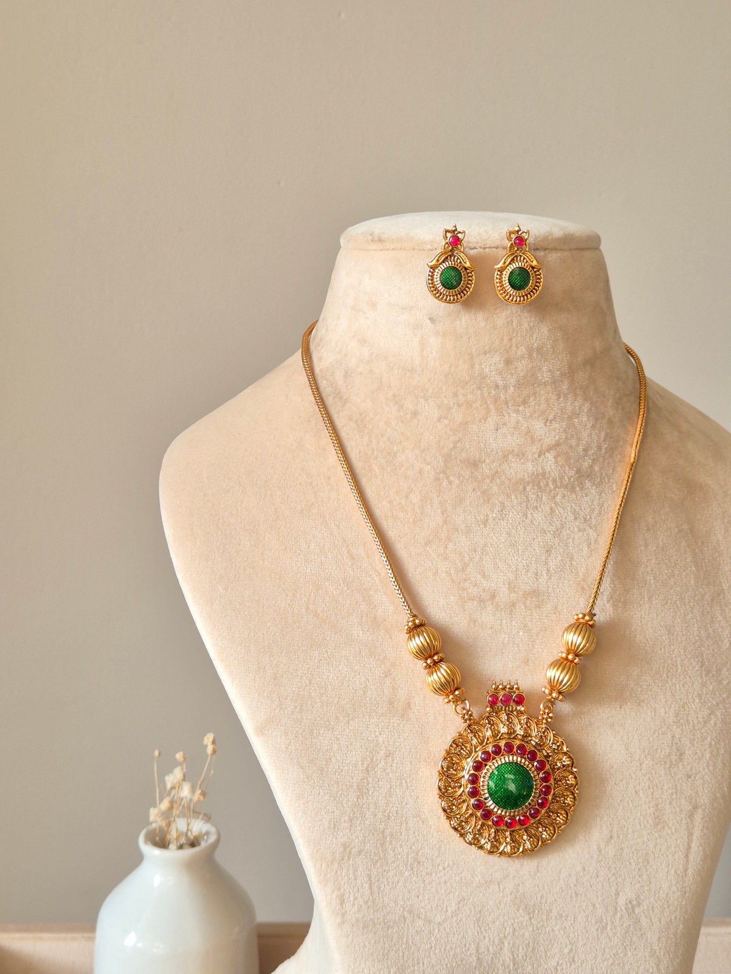 Gold necklace set, Antika by Naitri, traditional style on soft background.