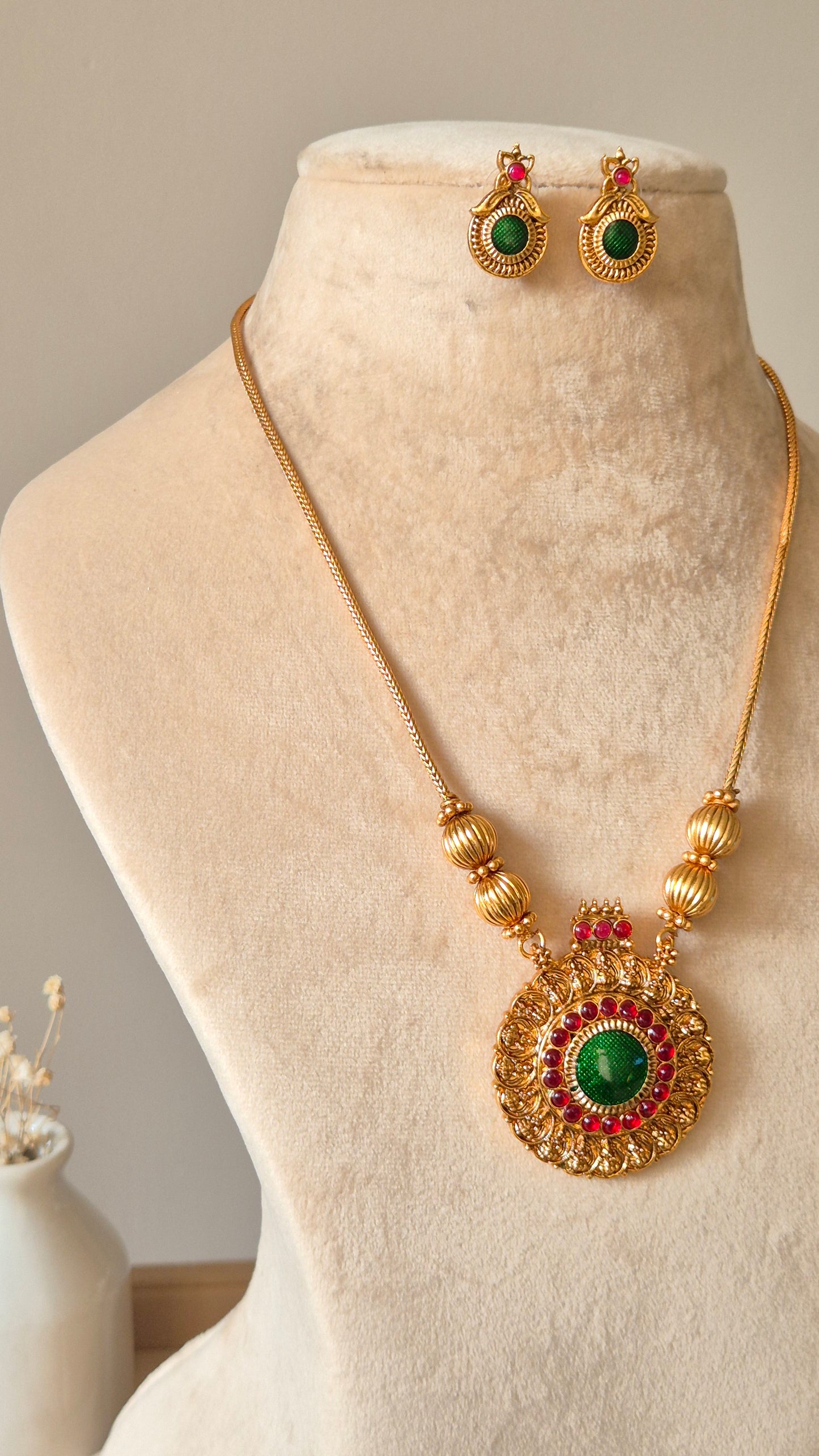 Gold necklace set, Antika by Naitri, traditional style on soft background.