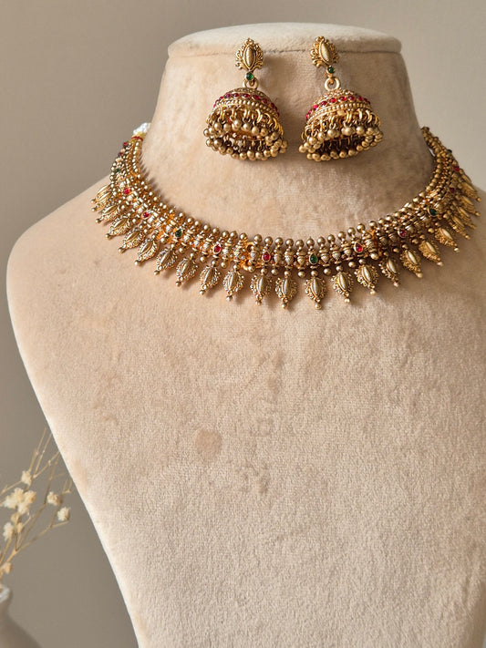 Gold necklace set with hanging coins, Rajasi by Naitri on white bust form.