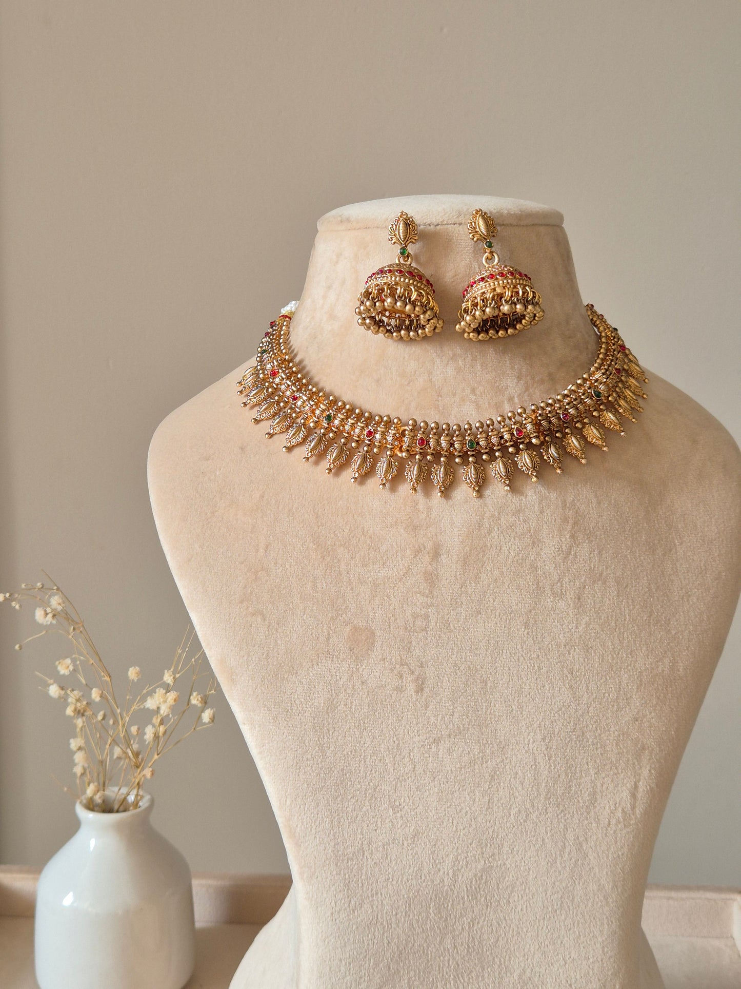 Gold necklace set with hanging coins, Rajasi by Naitri on white bust form.