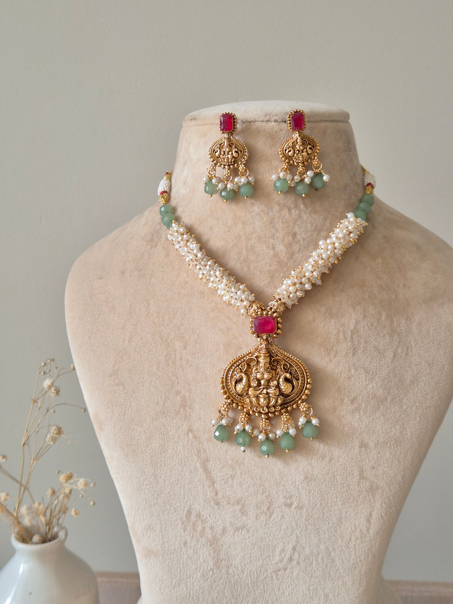 Multi-strand gold beaded necklace set, Richa by Naitri, with statement earrings.