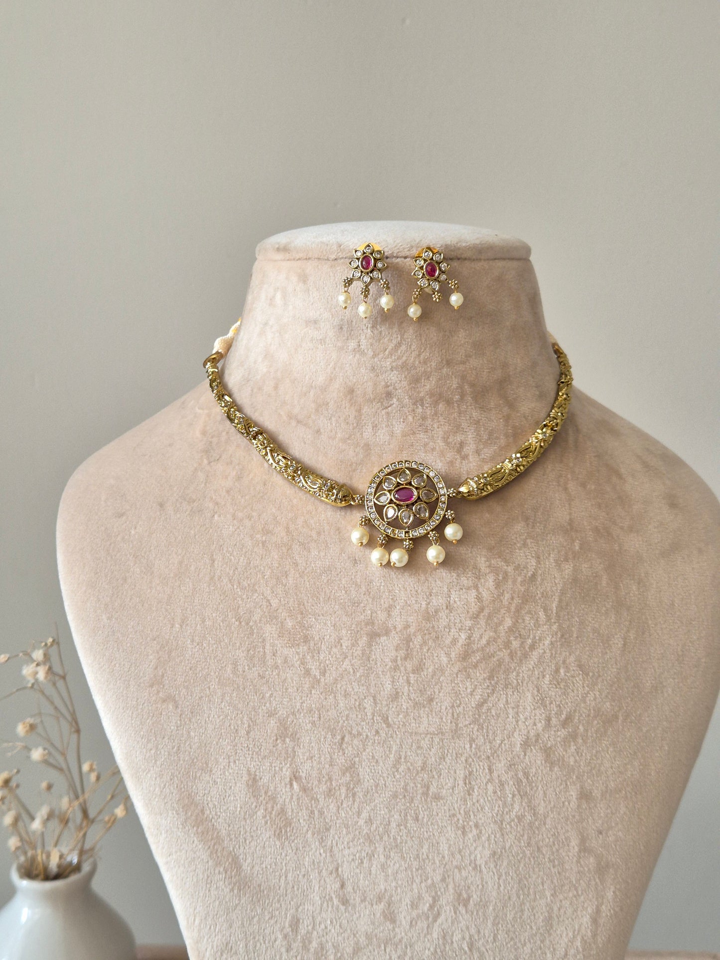 Gold necklace set with matching earrings, Vasundhra by Naitri on white background.