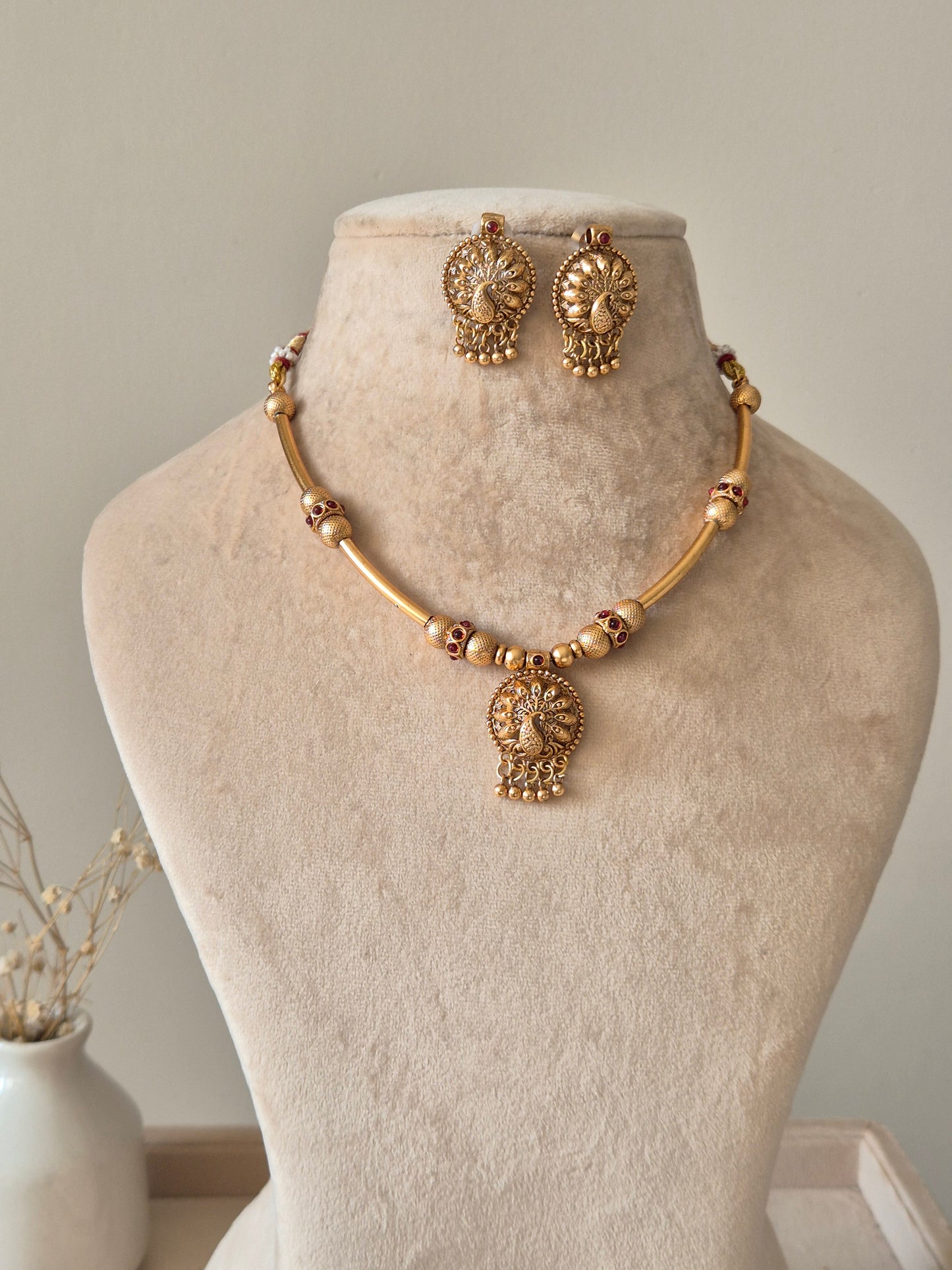 Gold beaded necklace with pendant, Shanaya by Naitri, displayed on white background.