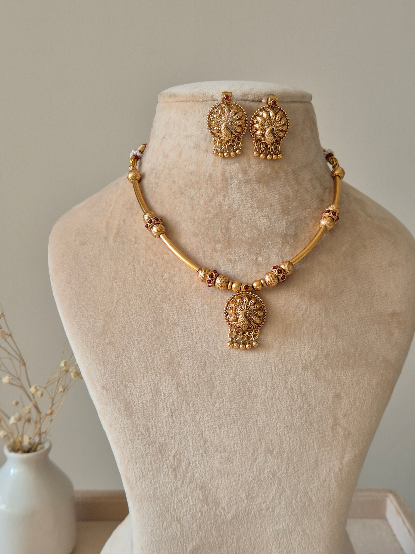 Gold beaded necklace with pendant, Shanaya by Naitri, displayed on white background.