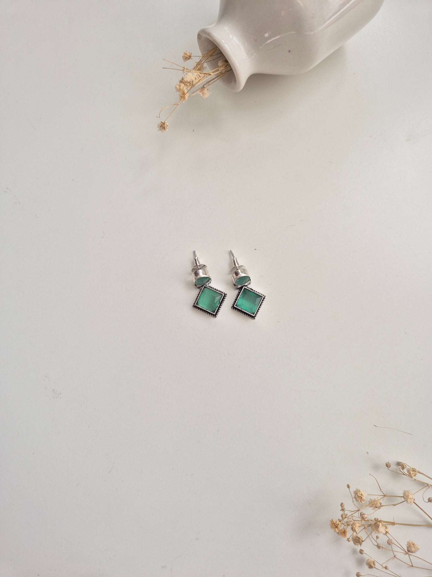 Oxidized Anisha Earrings with green glass accents, versatile handcrafted accessory.