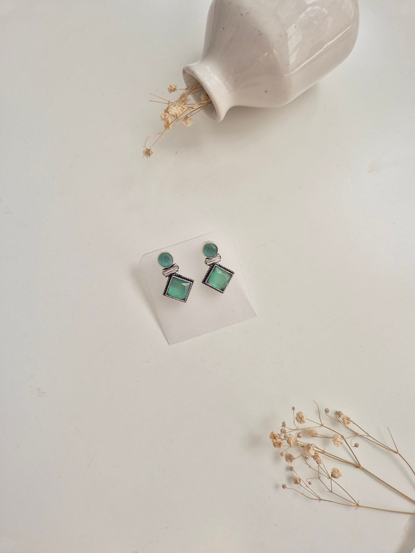 Oxidized Anisha Earrings with green glass accents, versatile handcrafted accessory.