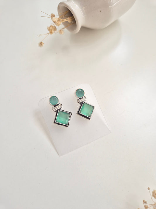 Oxidized Anisha Earrings with green glass accents, versatile handcrafted accessory.