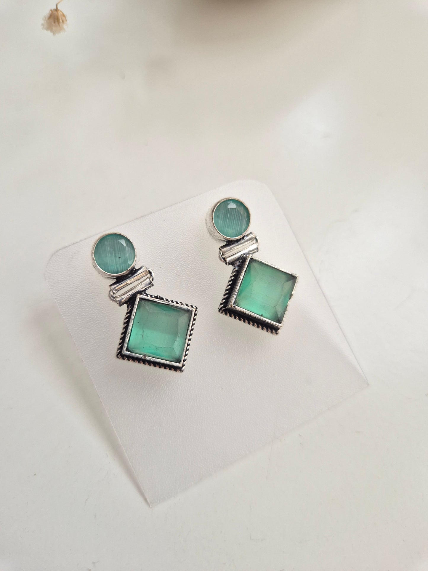 Oxidized Anisha Earrings with green glass accents, versatile handcrafted accessory.