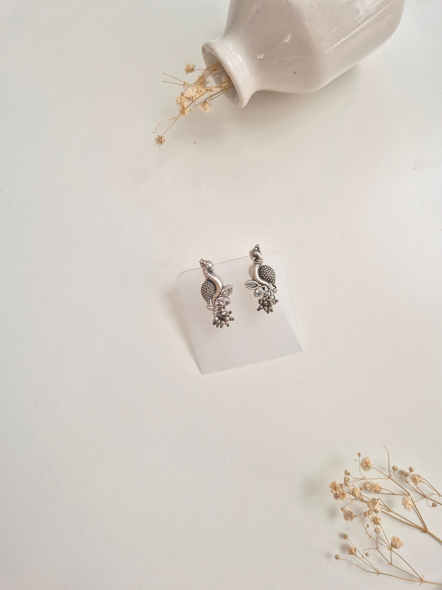 Premium handcrafted oxidized Hemal Earrings with silver and red dangle design.