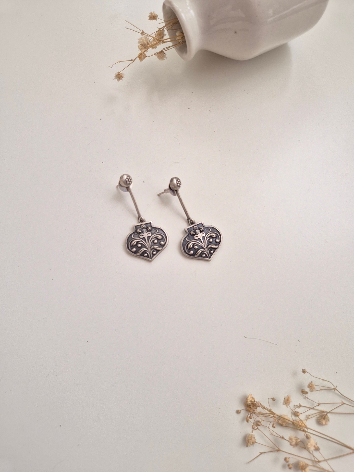 Silver look oxidized Ayati Earrings with dangle, drop, and stud styles, elegant and versatile.