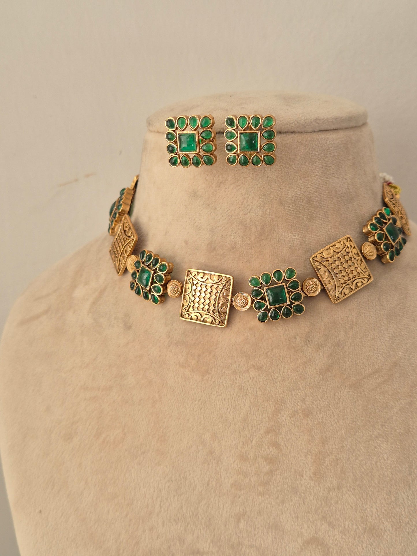 Lambika Necklace Set antique gold choker with green stone accents and matching stud earrings by Naitri