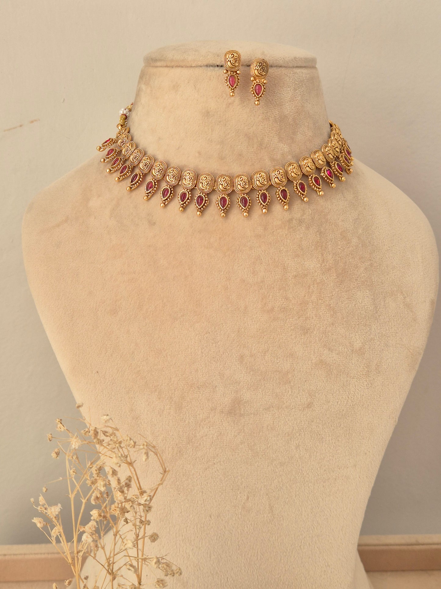 Traditional antique gold choker necklace set with ruby-pink stone accents and matching stud earrings