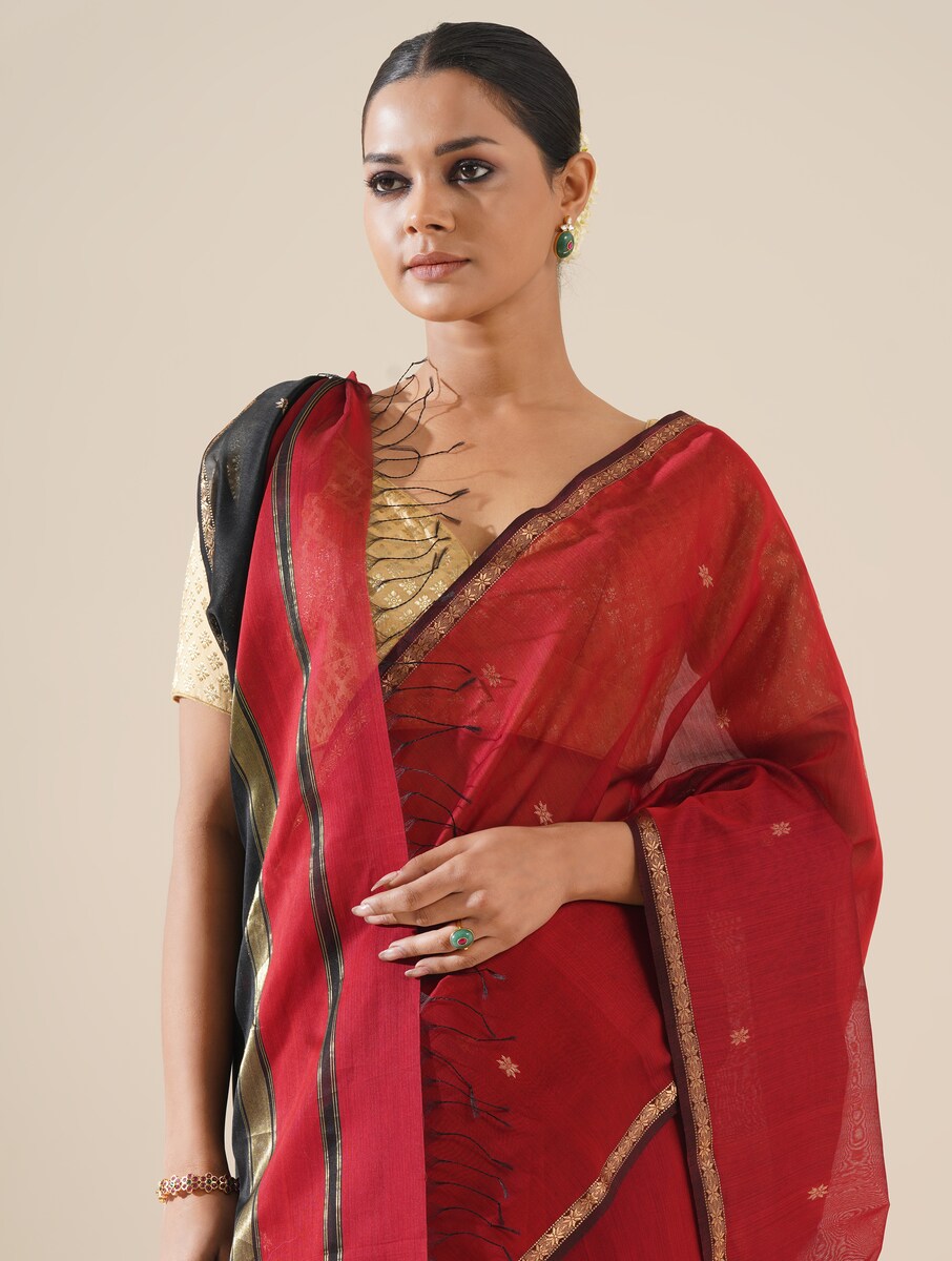 Red and black Maheshwari saree displayed on mannequin, showcasing traditional weave and fabric quality