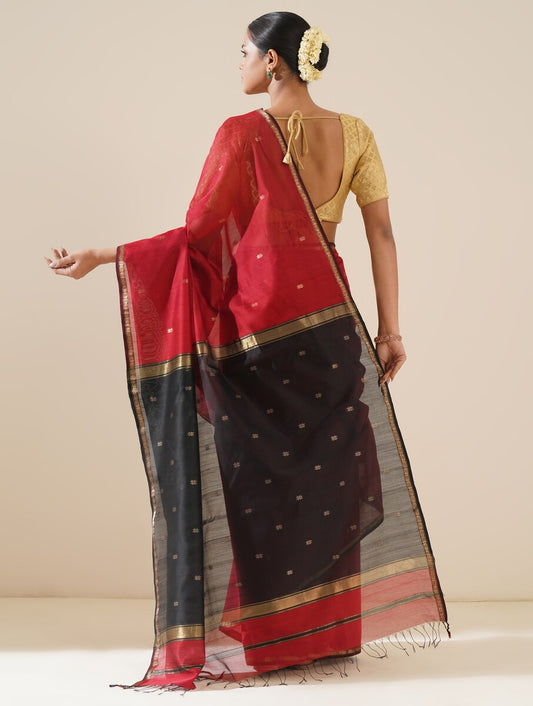Red and black Maheshwari saree displayed on mannequin, showcasing traditional weave and fabric quality