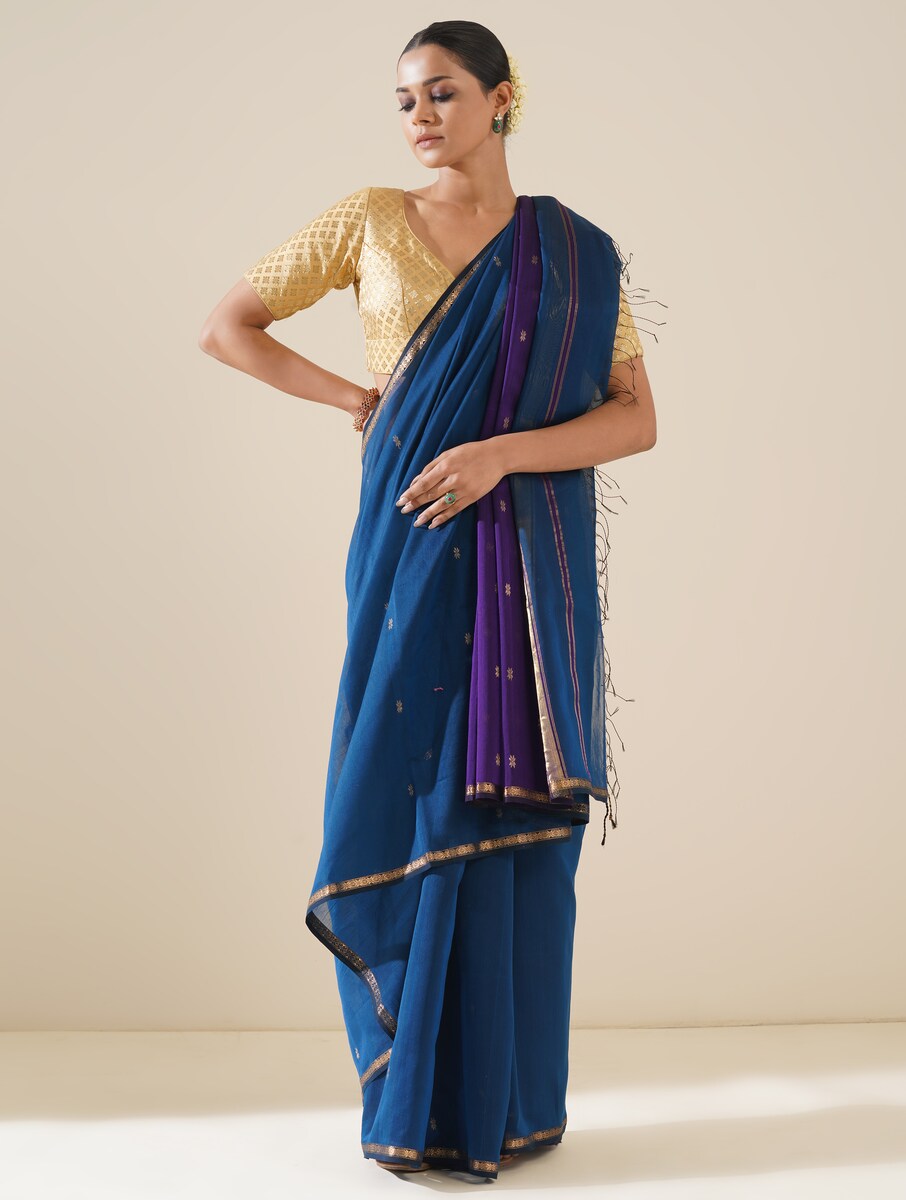 Bright cobalt blue and purple saree draped neatly to highlight delicate handwoven pattern and fabric texture