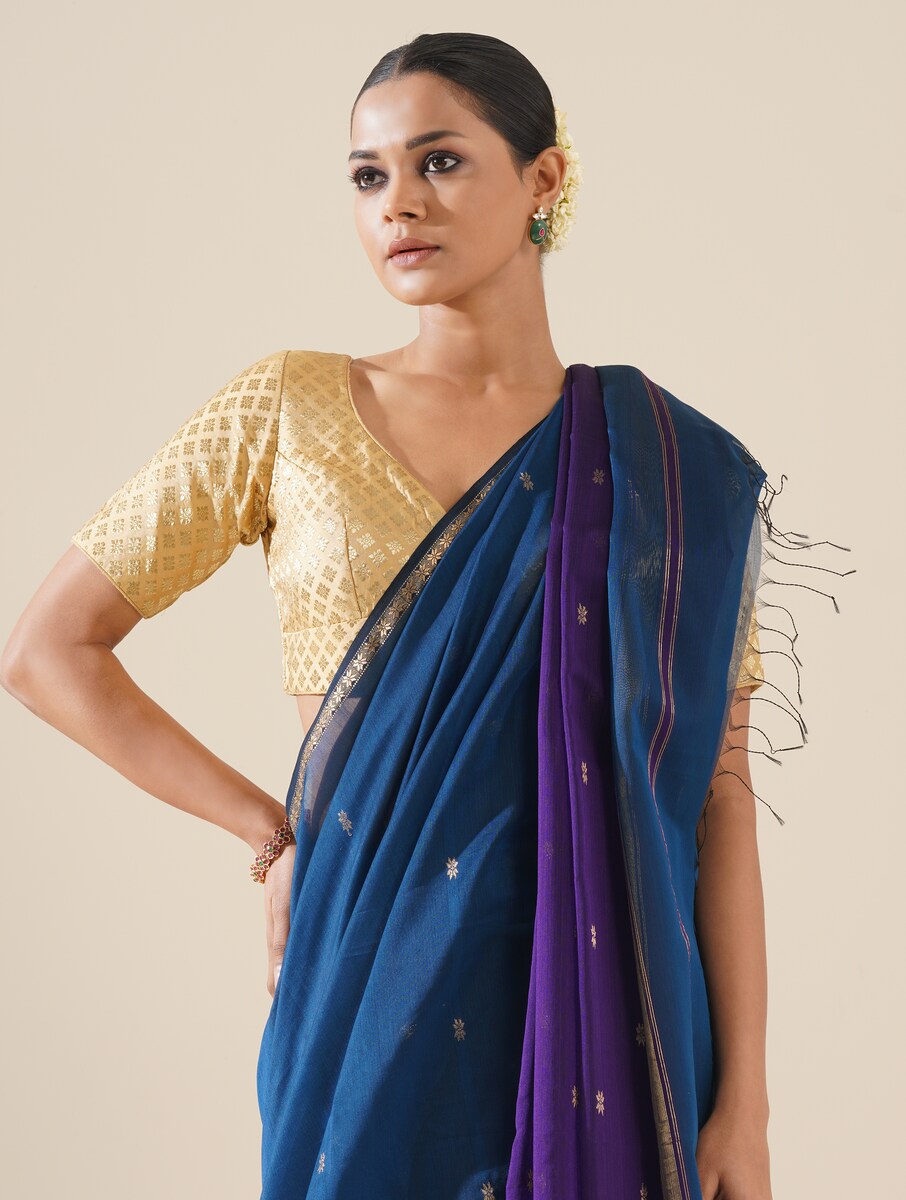 Bright cobalt blue and purple saree draped neatly to highlight delicate handwoven pattern and fabric texture