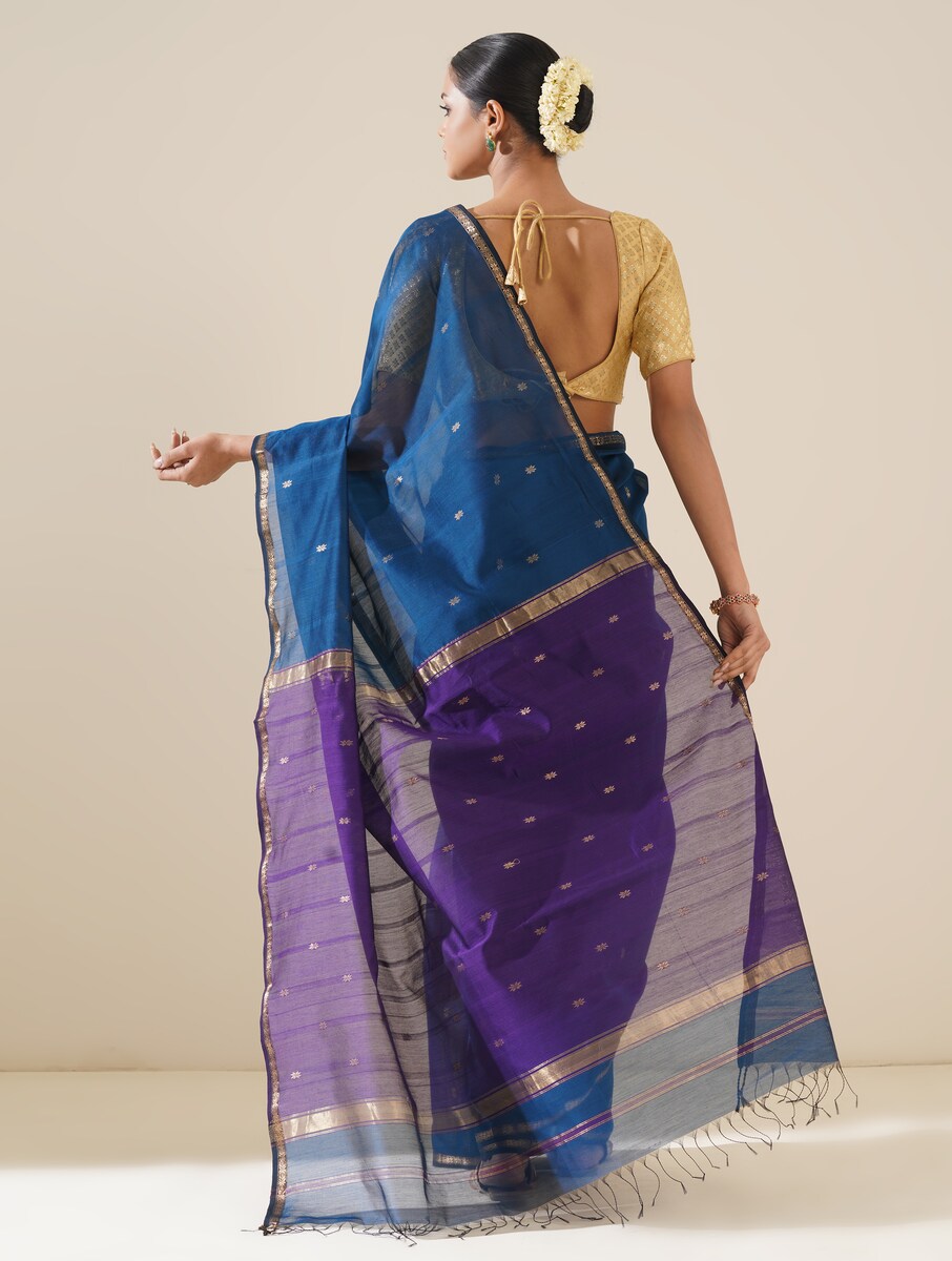 Bright cobalt blue and purple saree draped neatly to highlight delicate handwoven pattern and fabric texture