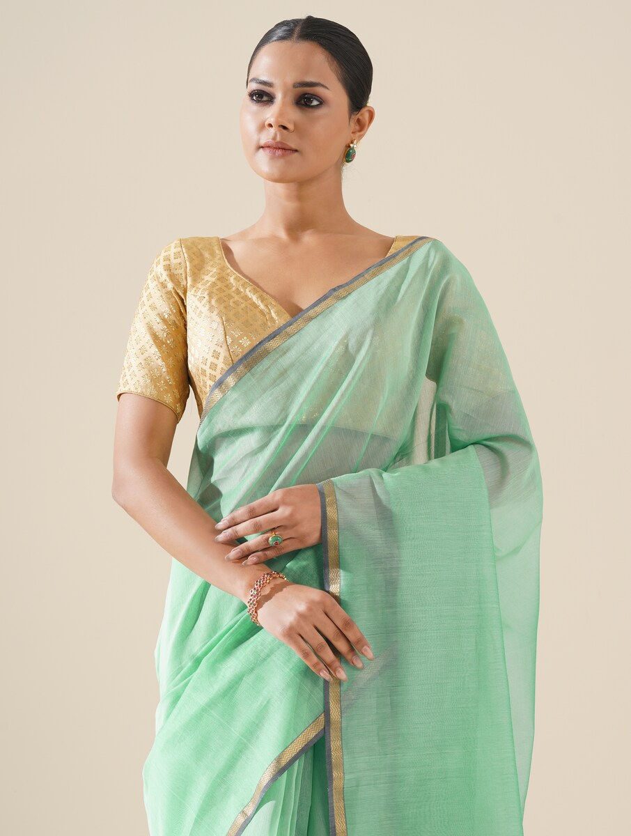 Aqua blue saree with kosa pallu arranged to showcase elegant handwoven details and silk texture