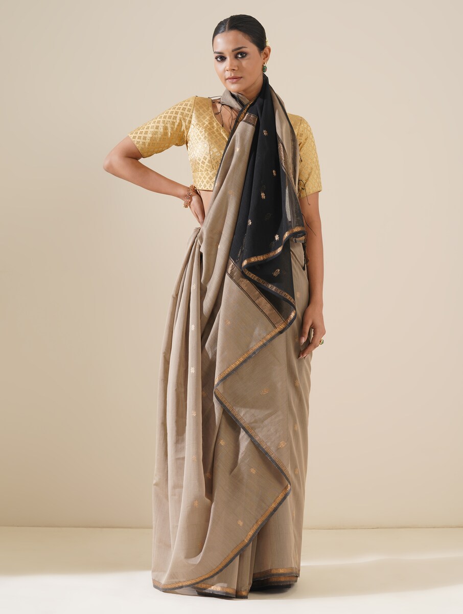 Beautiful grey and black saree draped on mannequin highlighting traditional craftsmanship and silk texture