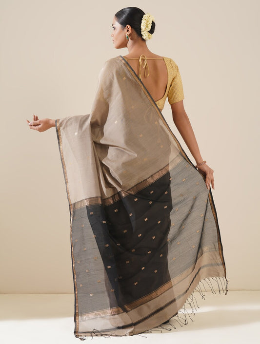 Beautiful grey and black saree draped on mannequin highlighting traditional craftsmanship and silk texture