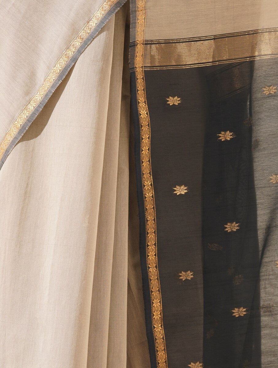 Beautiful grey and black saree draped on mannequin highlighting traditional craftsmanship and silk texture