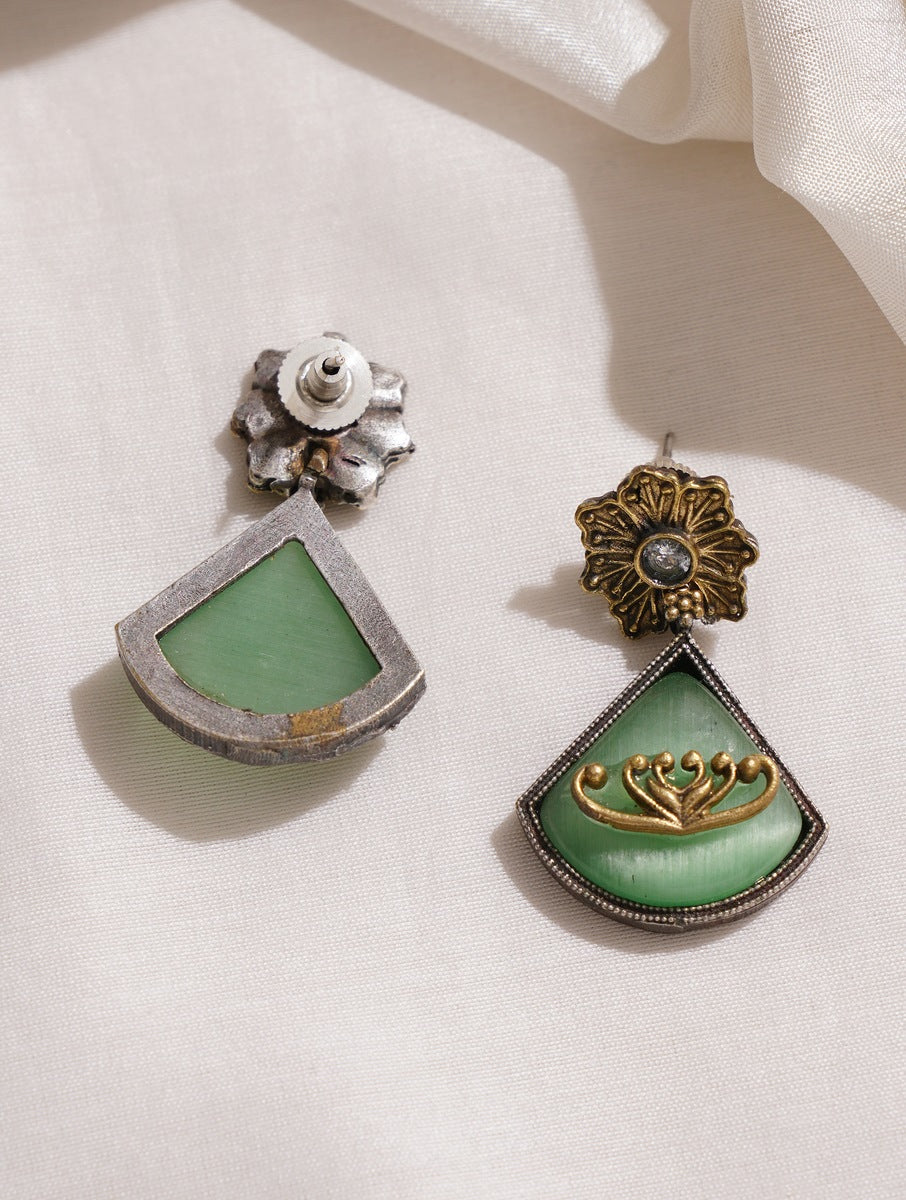 Dual-tone green and red brass dangle earrings on minimalist backdrop