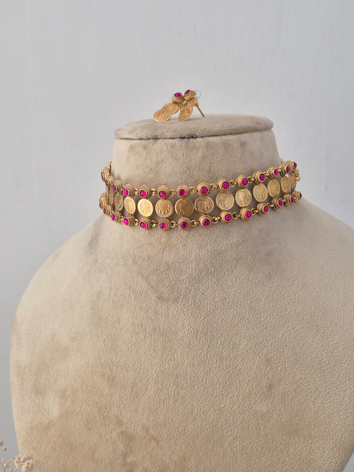 Handcrafted ethnic brass alloy choker necklace featuring traditional motifs and red gemstone details with matching earrings by Naitri.in
