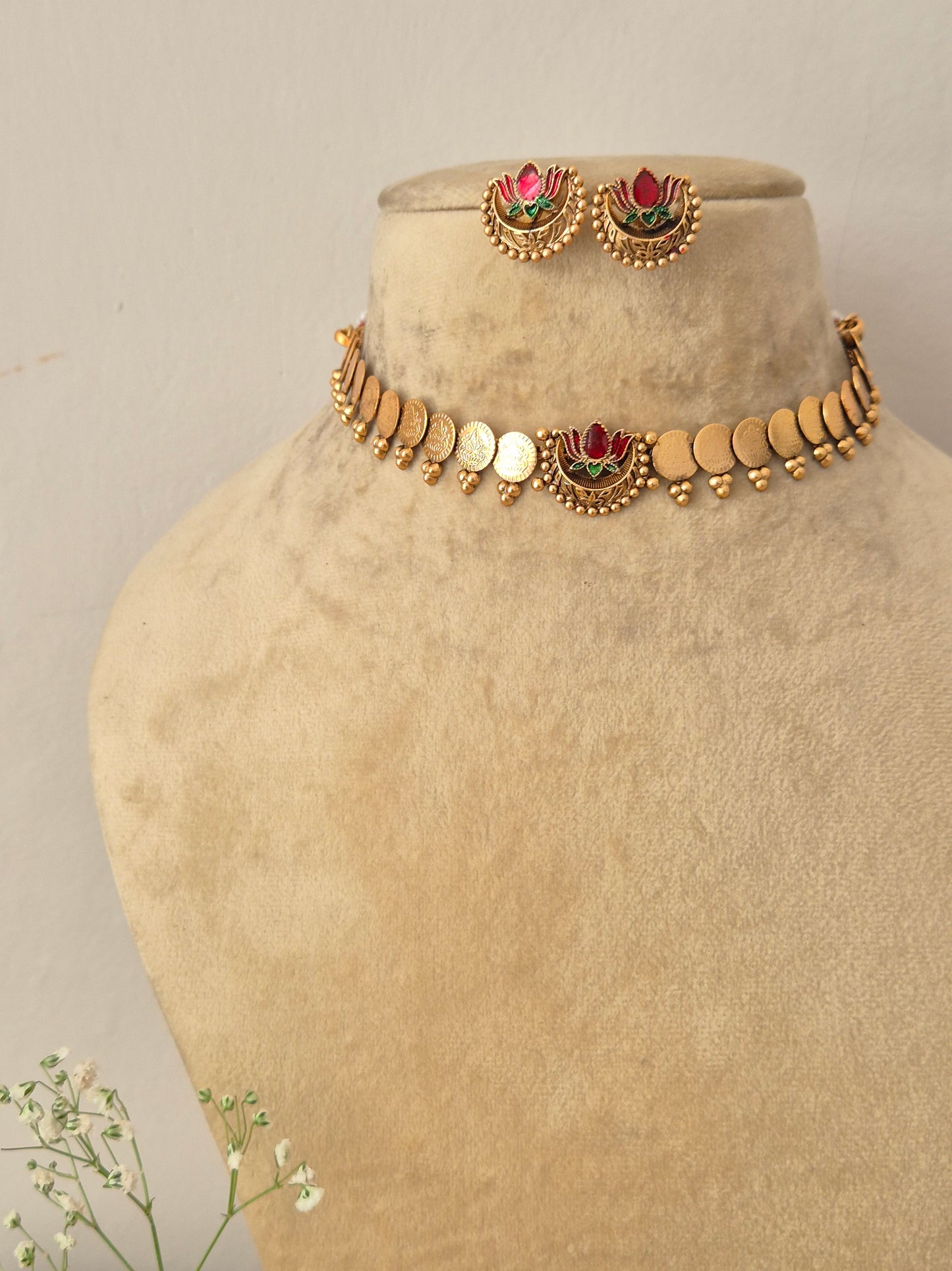 Elegant lotus-themed gold-toned traditional choker jewelry set Naitri gold-plated Akira choker and earring set with lotus motifs by naitri.in