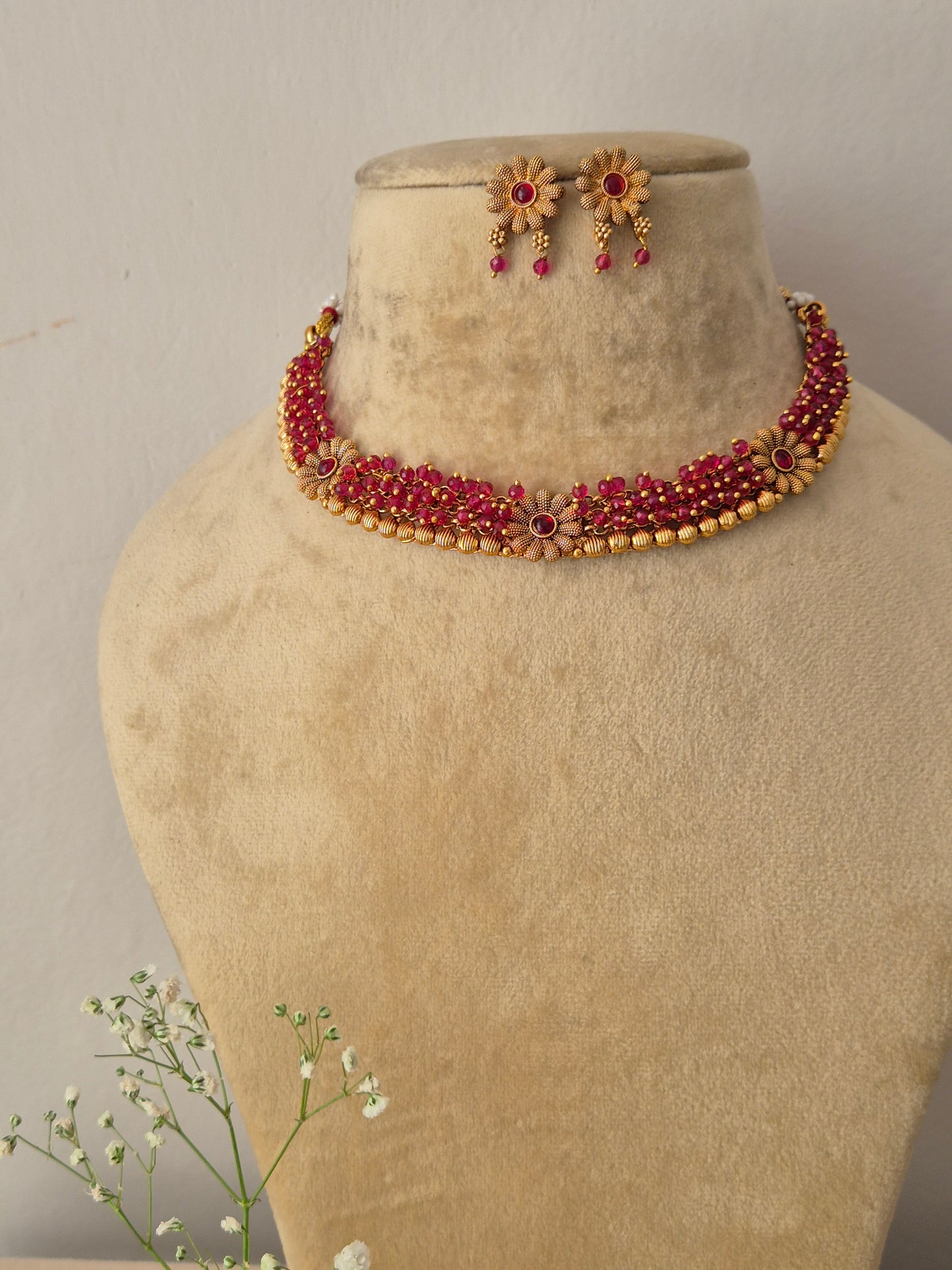 Elegant pink-red gemstone and gold-toned ethnic choker jewelry set, by naitri.in