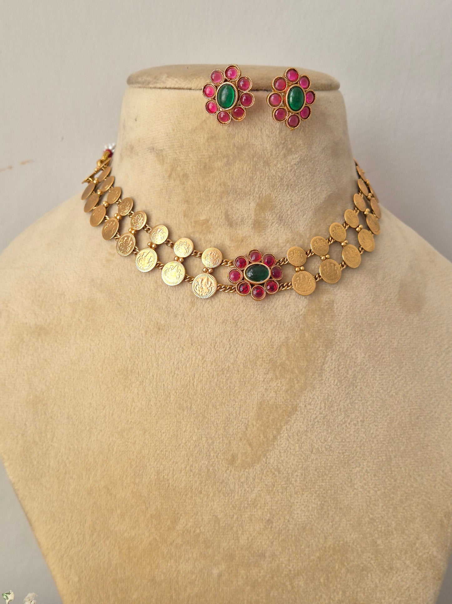 Handcrafted antique gold statement jewelry set showcasing festive pink and green floral accents by naitri.in