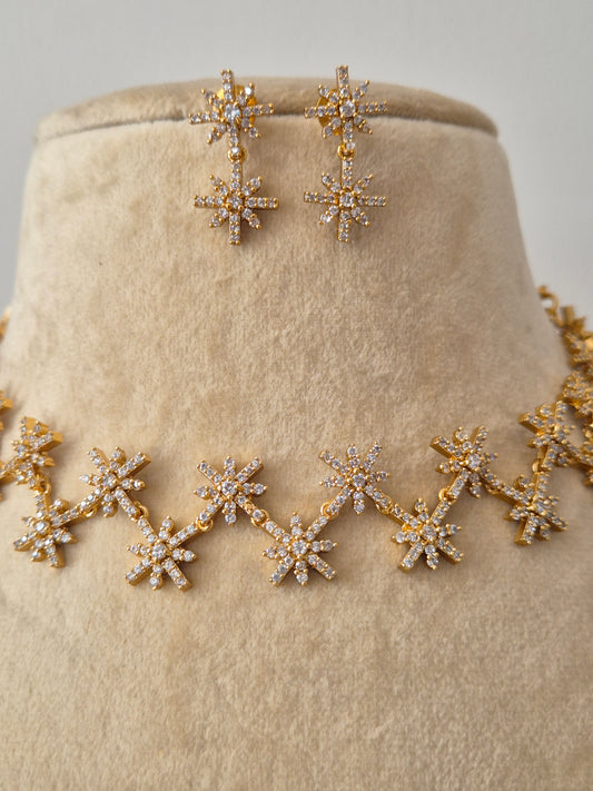 Handcrafted jewelry set in brass alloy with a polished golden finish and dazzling American diamond-style stone embellishments by naitri.in