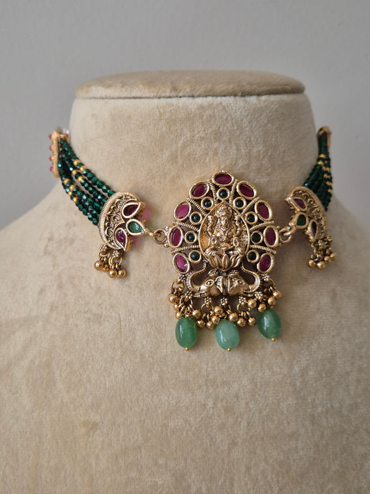 Antique gold choker necklace set with green beads and Goddess Lakshmi motif pendant by naitri.in
