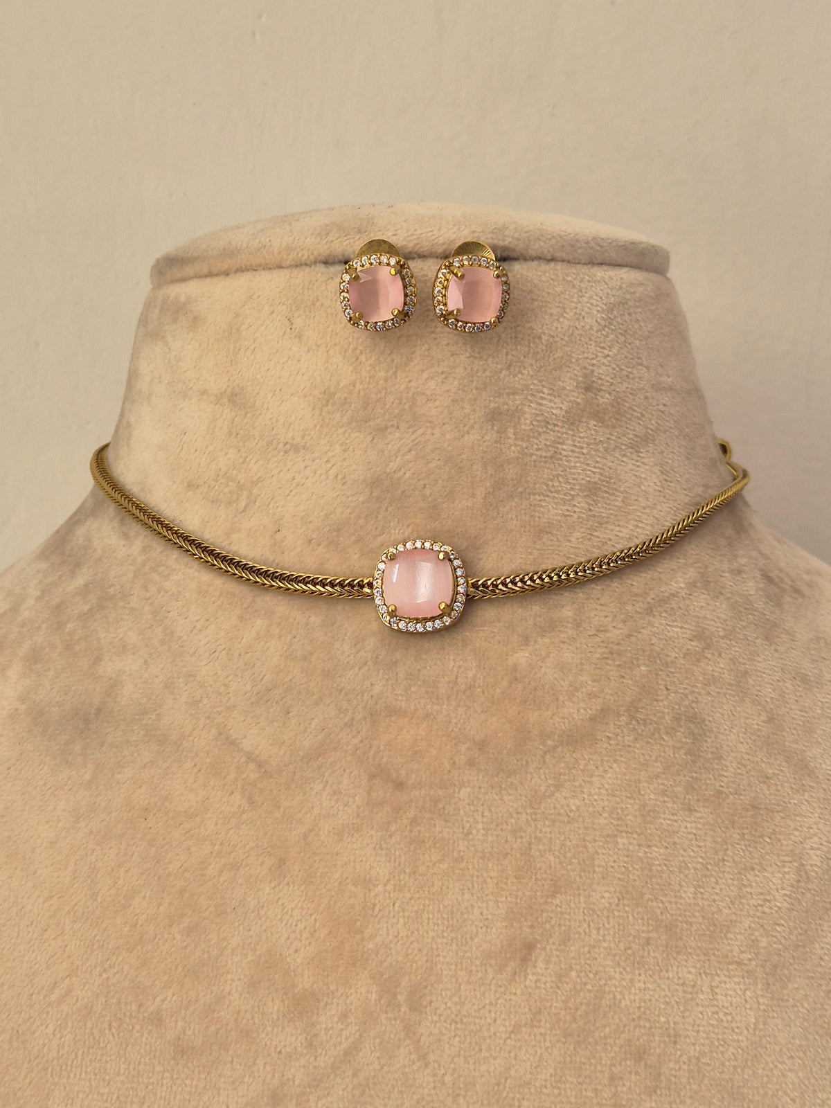 Gold chain choker necklace set with a pink stone center Delicate gold choker necklace with a blush pink stone pendant and matching stud earrings by naitri.in