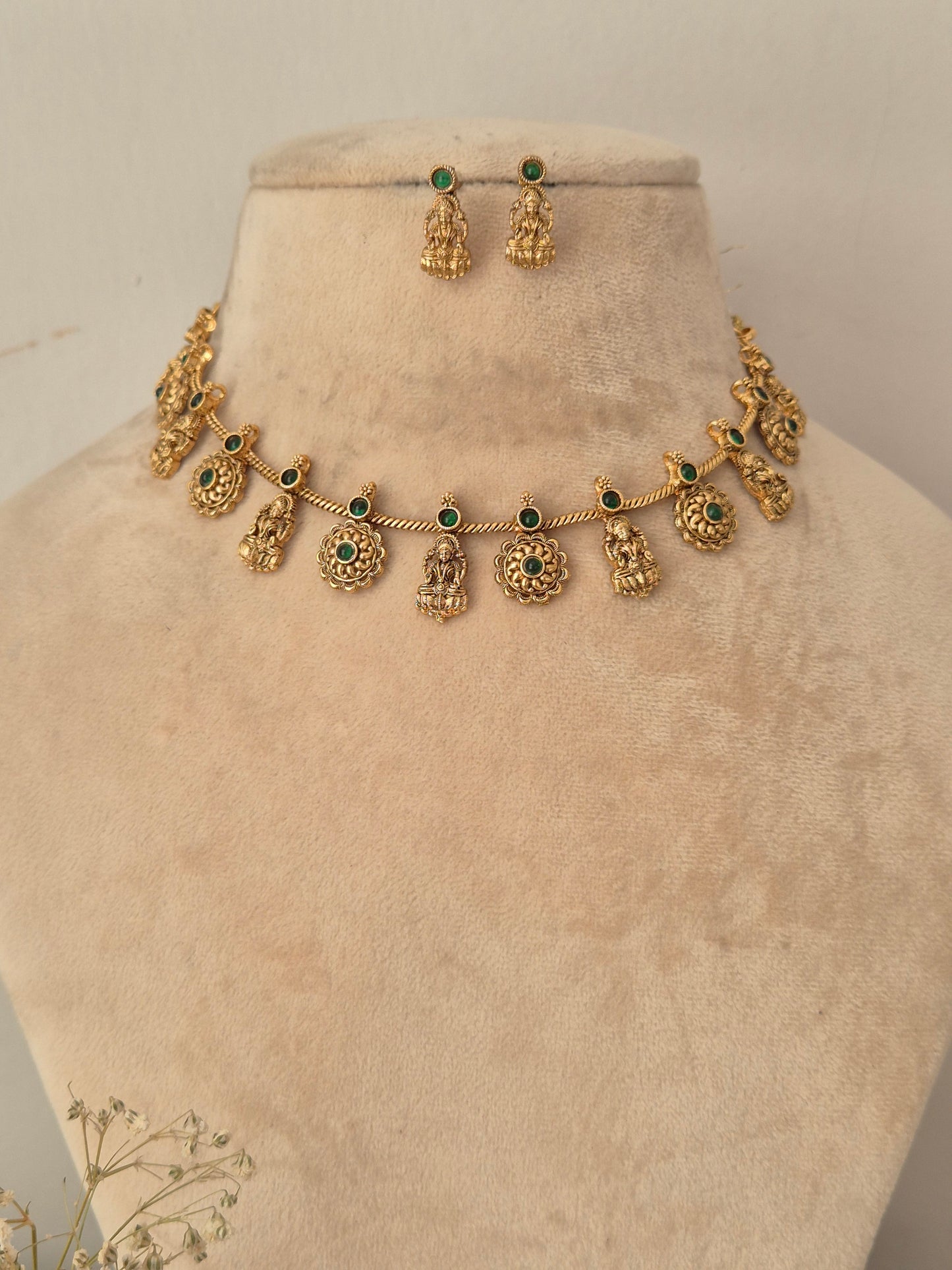 Gold-toned traditional necklace and matching drop earrings displayed by naitri.in