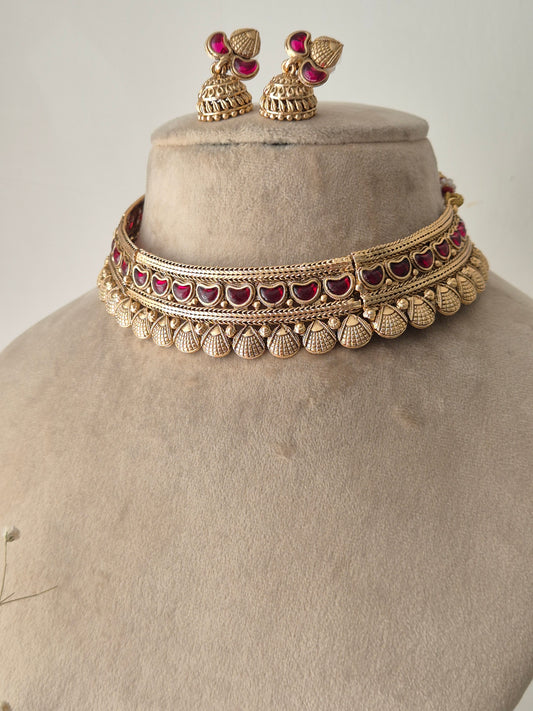 Traditional Indian Gold Jewellery Set with Red Stones and Matching Earrings by naitri.in